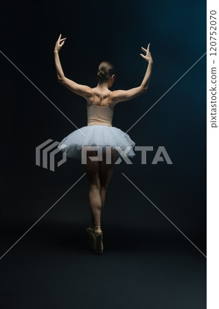 Beautiful ballet dancer showcasing posture in elegant white tutu Beautiful ballet dancer showcasing posture in elegant white tutu 120752070
