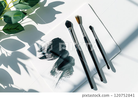 Creative table with canvas for sketches and paintbrushes set on white  table, top view 120752841