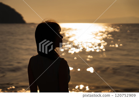 Ocean sunset and woman silhouette 120752909