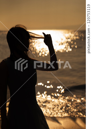 Ocean sunset and woman silhouette Ocean sunset and woman silhouette 120753119