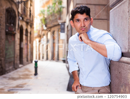 Young European guy in blue shirt walking around city Young European guy in blue shirt walking around city 120754903
