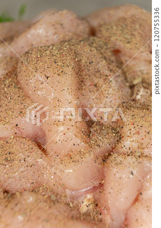 Raw chicken fillet sprinkled with spices, ground pepper mixture Raw chicken fillet sprinkled with spices, ground pepper mixture 120755336