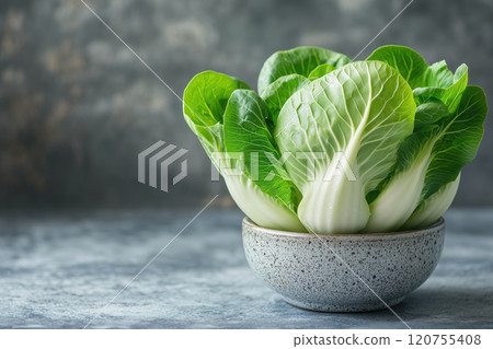 Green bock choi in textured bowl placed on table in minimal setting, healthy food and green vegetables concept, copy space 120755408