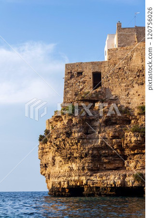 Traditional houses on dramatic cliffs rising from Adriatic sea in Polignano a Mare, Italy Traditional houses on dramatic cliffs rising from Adriatic sea in Polignano a Mare, Italy 120756026