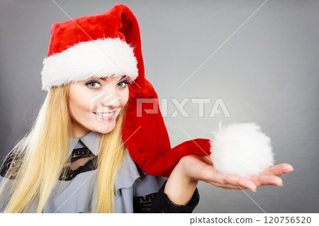 Happy woman wearing Santa Claus helper hat 120756520