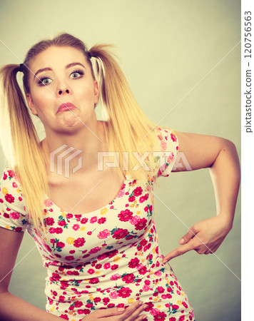 Funny teenage woman holding their stomach Funny teenage woman holding their stomach 120756563