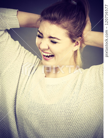 Unhappy woman screaming and yelling in pain 120756577
