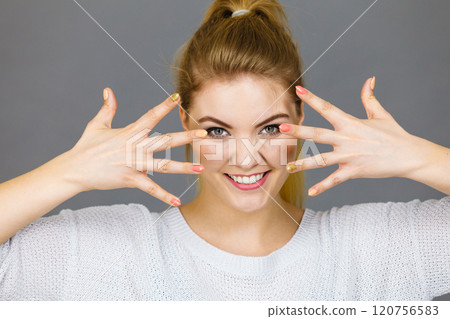 Happy woman showing her hands 120756583
