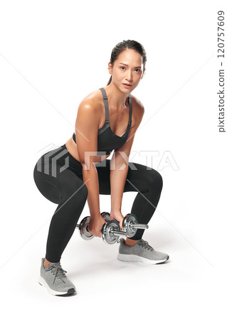 an asian woman is working out with dumbbells wearing the sport exercise suit with white background, 120757609