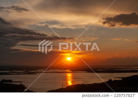 Majestic sunset casts golden reflections over the tranquil waters of Sviyazhsk Majestic sunset casts golden reflections over the tranquil waters of Sviyazhsk 120757827