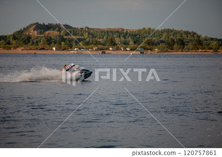 Exciting jet ski adventure on the Vilga river during a sunny afternoon Exciting jet ski adventure on the Vilga river during a sunny afternoon 120757861