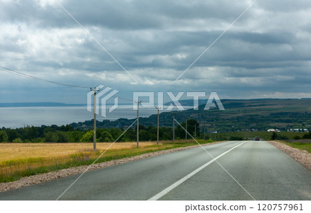 Journey along the Vilga river with rolling hills and overcast skies framing the peaceful landscape Journey along the Vilga river with rolling hills and overcast skies framing the peaceful landscape 120757961