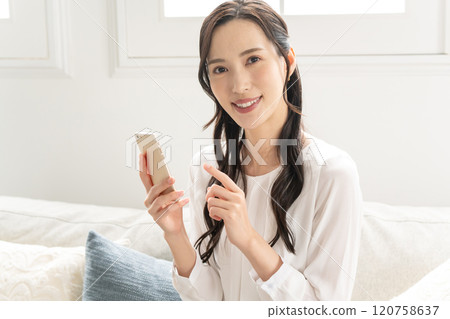 Woman operating a smartphone 120758637