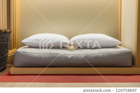 Cozy bedding setup with neutral colors in a minimalist interior design Cozy bedding setup with neutral colors in a minimalist interior design 120758697