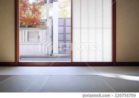 Tranquil view from a wabi sabi room overlooking autumn foliage and a quiet street Tranquil view from a wabi sabi room overlooking autumn foliage and a quiet street 120758709