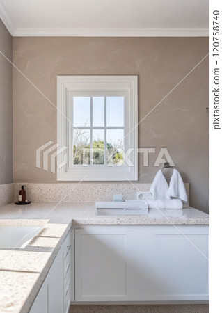 Modern bathroom interior featuring elegant design and natural light from window Modern bathroom interior featuring elegant design and natural light from window 120758740
