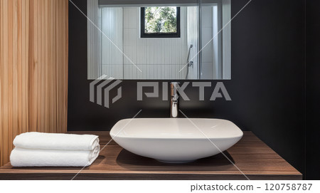 Modern bathroom design with elegant sink and neatly arranged towels Modern bathroom design with elegant sink and neatly arranged towels 120758787