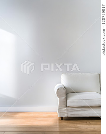 White couch positioned near a sunlit wall in a minimalist room 120759017