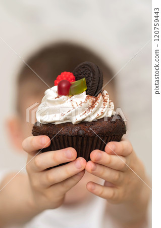 Close-up cake in the hands of a child Close-up cake in the hands of a child 120759443