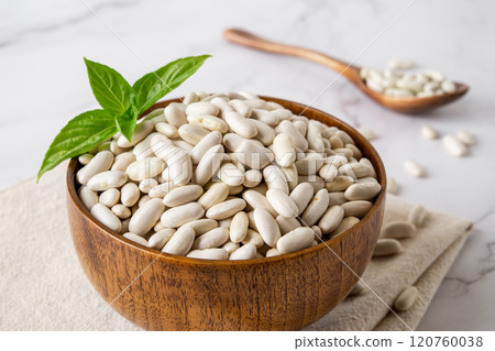 Close-up of white kidney beans in a wooden bowl. Close-up of white kidney beans in a wooden bowl. 120760038