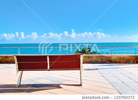 Serene view of bench overlooking blue Mediterranean Sea. Spain Serene view of bench overlooking blue Mediterranean Sea. Spain 120760372