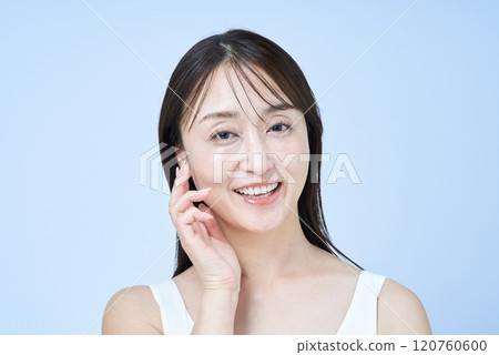 Middle-aged woman touching her skin 120760600