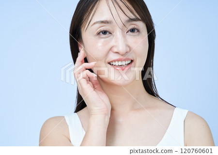 Middle-aged woman touching her skin 120760601