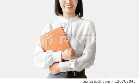 Smiling woman/businesswoman holding a file Smiling woman/businesswoman holding a file 120762045