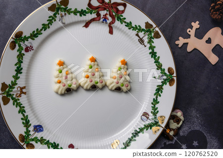 Christmas chocolates. Chocolate Christmas tree in a Christmas plate. 120762520