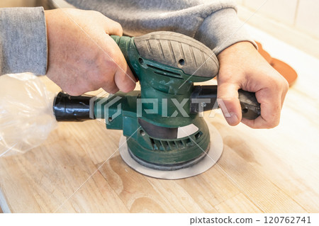 Work with a grinder on wood. Work tool. Work with a grinder on wood. Work tool. 120762741