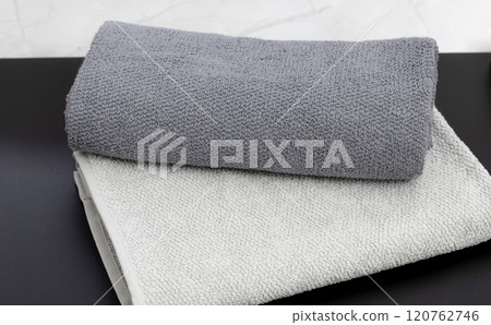 Folded clean towels on a black background. Folded clean towels on a black background. 120762746
