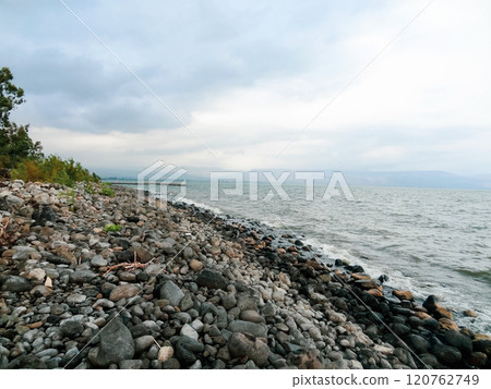 Rocky shore of the sea or lake.The sea of Galilee also called Lake Tiberias or Kinneret, Israel. 120762749