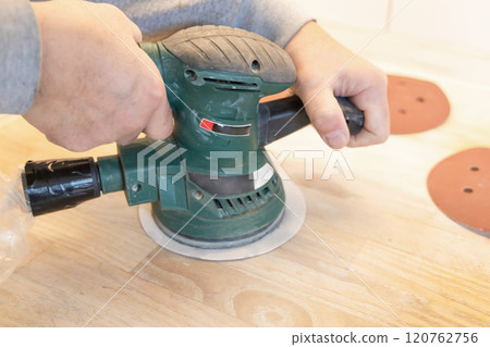 Work with a grinder on wood. Work tool. 120762756