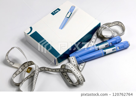 Hands in surgical gloves holding Ozempic Insulin injection pen for diabetics. 120762764