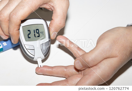 Diabetic man measuring blood sugar level. High blood sugar hyperglycemia. 120762774