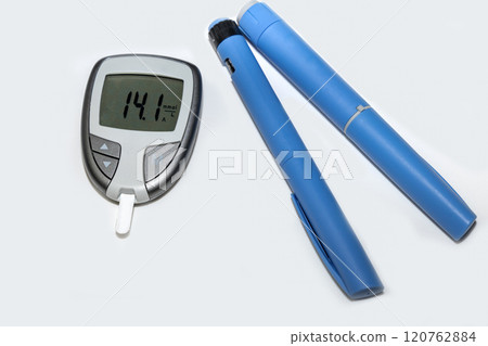 Blood sugar meter with test strips indicates high blood sugar levels and injection pen for diabetes. Blood sugar meter with test strips indicates high blood sugar levels and injection pen for diabetes. 120762884