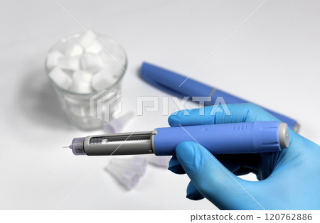 Hands in surgical gloves holding Ozempic Insulin injection pen for diabetics. Hands in surgical gloves holding Ozempic Insulin injection pen for diabetics. 120762886