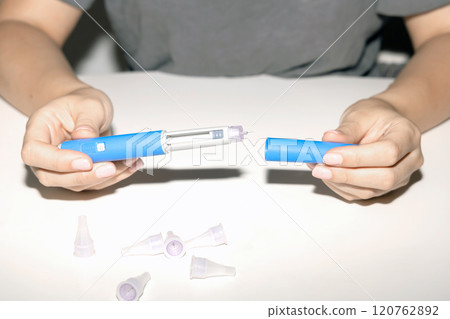 Female hands holding an insulin pen. Ozempic Insulin injection pen. 120762892