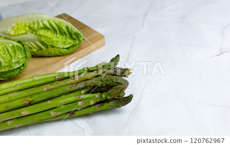 Fresh vegetables on the kitchen table cabbage, salad, asparagus. 120762967