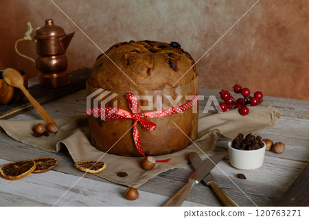 Italian Christmas Cake Panettone with red bow on wooden rustic background 120763271