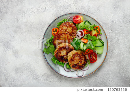 fried chicken cutlets, minced chicken, with vegetables, on gray , with vegetable salad, top view, homemade, no people, fried chicken cutlets, minced chicken, with vegetables, on gray , with vegetable salad, top view, homemade, no people, 120763536