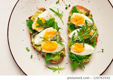 sandwich with mashed avocado, boiled egg, and arugula, on bread , homemade, breakfast, sandwich with mashed avocado, boiled egg, and arugula, on bread , homemade, breakfast, 120763542