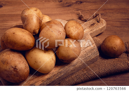 Raw potatoes, scattered on a chopping board, close-up, no people, Raw potatoes, scattered on a chopping board, close-up, no people, 120763566