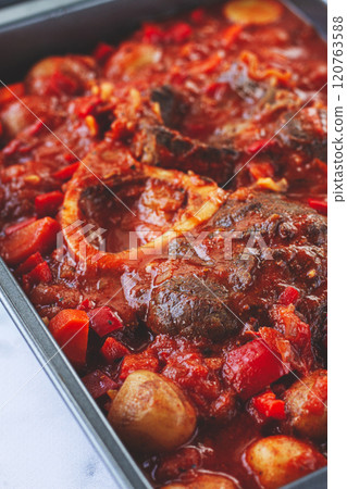 ossobuco stew with vegetables, knuckle on the bone with new potatoes, in tomato sauce,homemade, top view, no people, ossobuco stew with vegetables, knuckle on the bone with new potatoes, in tomato sauce,homemade, top view, no people, 120763588