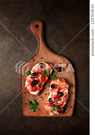 sandwich with cream cheese, prosciutto with olives , breakfast, 120763610