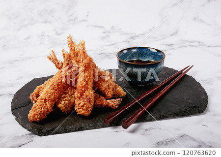 shrimp in tempura, deep fried, on black slate, with sauce, light marble table, no people, 120763620