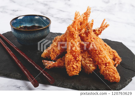shrimp in tempura, deep fried, on black slate, with sauce, light marble table, no people, 120763629