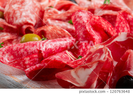 Assorted, meat appetizer, prosciutto, salami and ham, with olives , close-up, breakfast, top view, close-up, without people 120763648