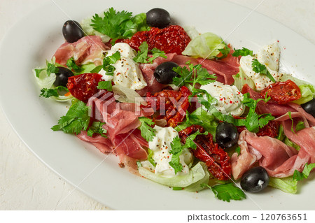 salad with dried tomatoes, prosciutto, soft cheese, olives, homemade, top view, salad with dried tomatoes, prosciutto, soft cheese, olives, homemade, top view, 120763651