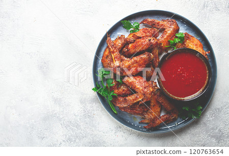fried in the oven, chicken wings, with spices, tomato sauce, on a plate, gray background, no people, homemade, fried in the oven, chicken wings, with spices, tomato sauce, on a plate, gray background, no people, homemade, 120763654